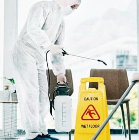 man spraying anti covid 19
